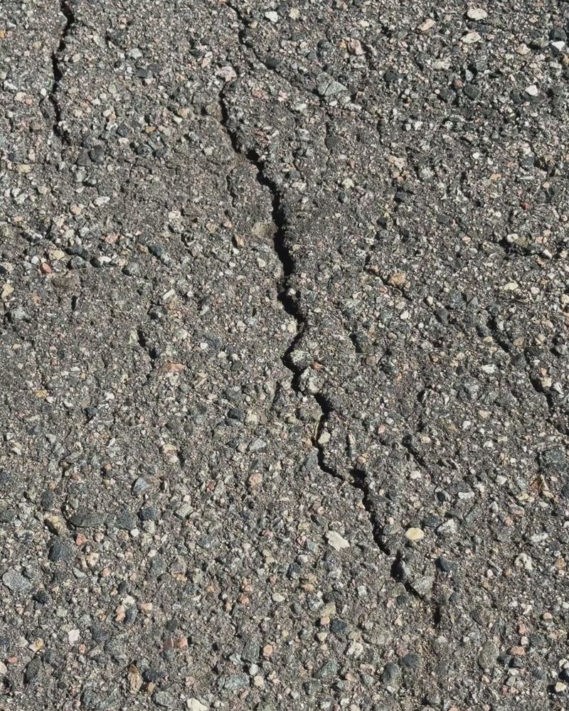 A single long crack running through asphalt